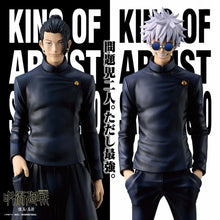 Two anime character figurines in dark uniforms with text on a black and white background.