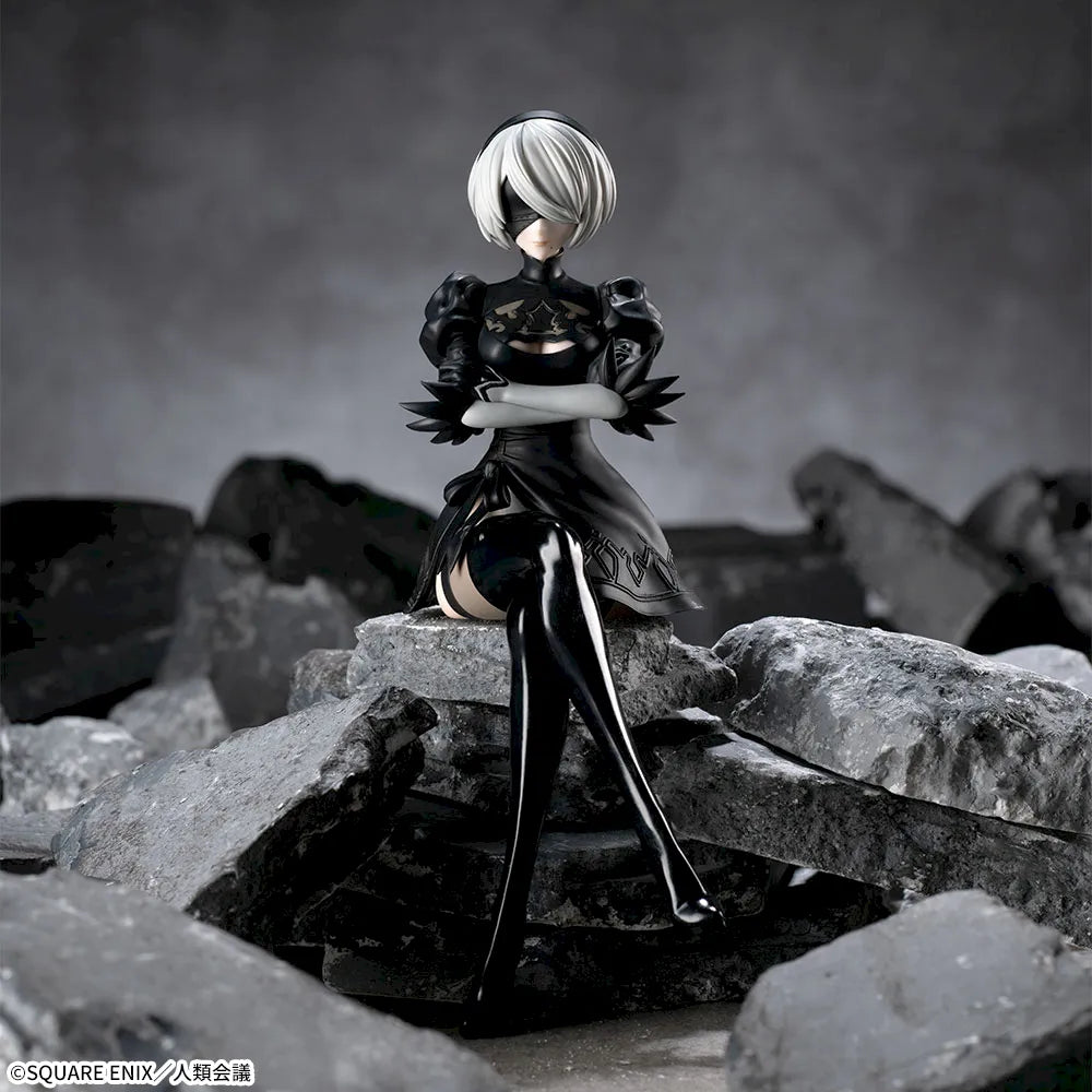 Figurine of a character from a video game standing on rocky terrain with a dark background.