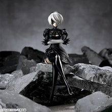 Figurine of a character from a video game standing on rocky terrain with a dark background.